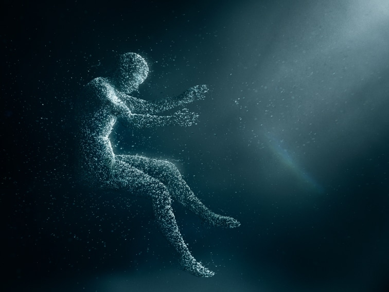 An animated person made out of particles floating in a sitting position. The person faces rays of light entering from the top right corner.